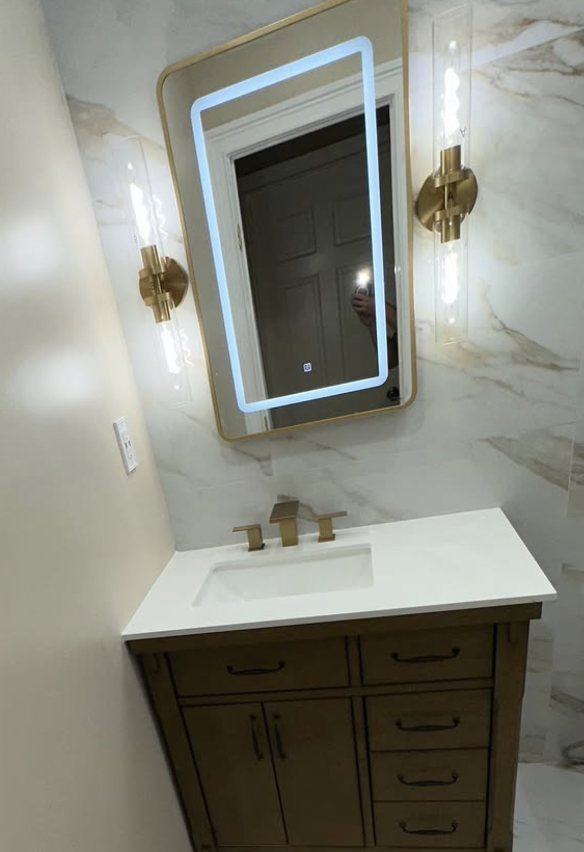 Wood vanity with lighted mirror by Zollinger Construction in South Amboy, NJ