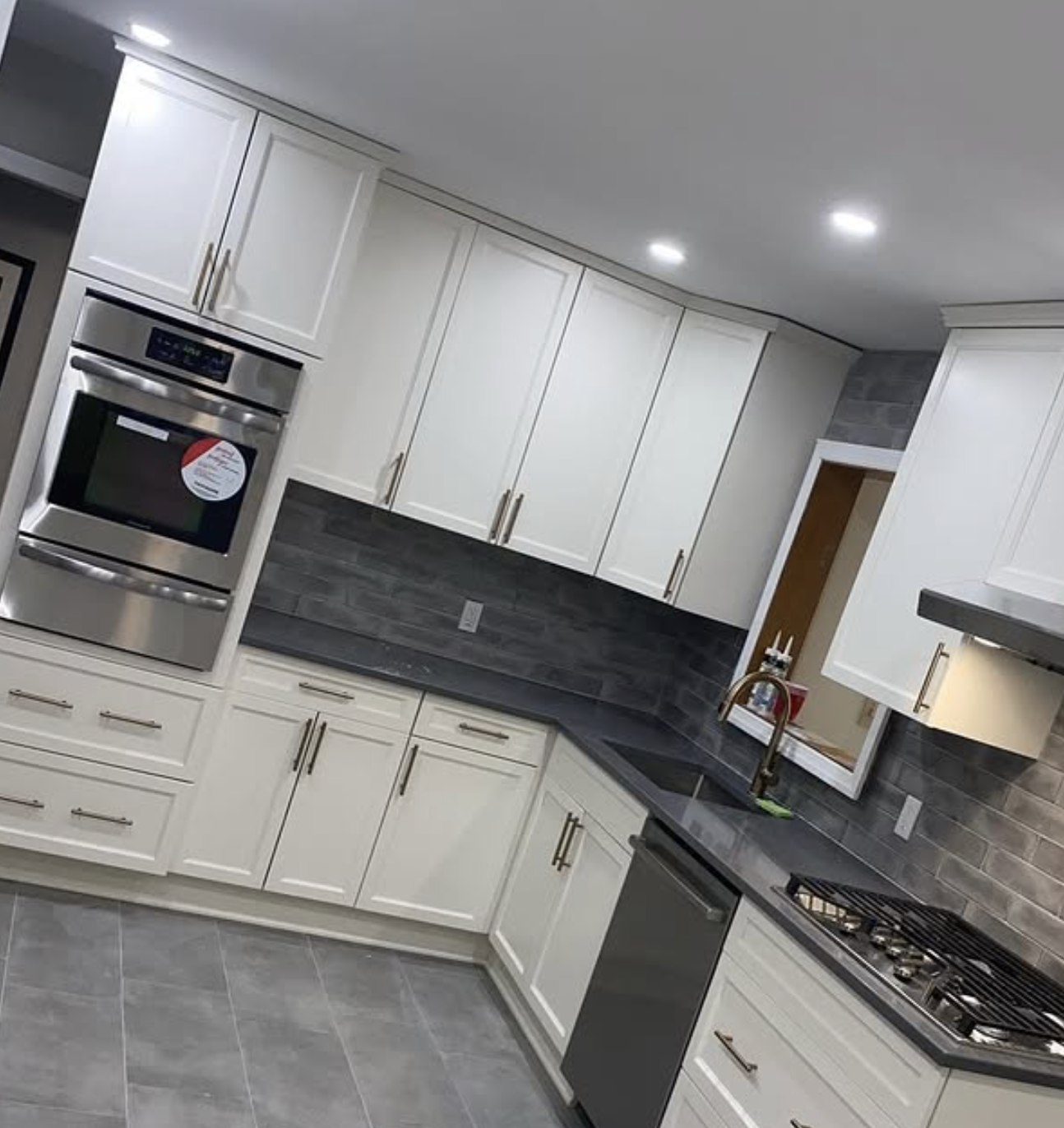 White kitchen with dark backsplash in East Brunswick, NJ