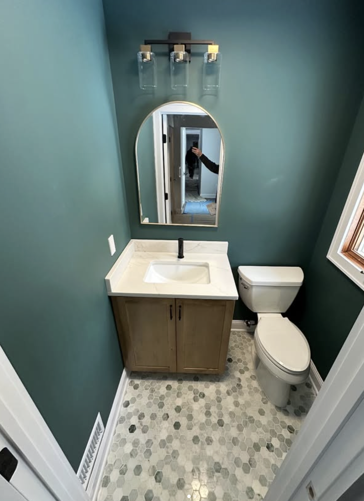 Teal powder room by Zollinger Construction in Parlin, NJ