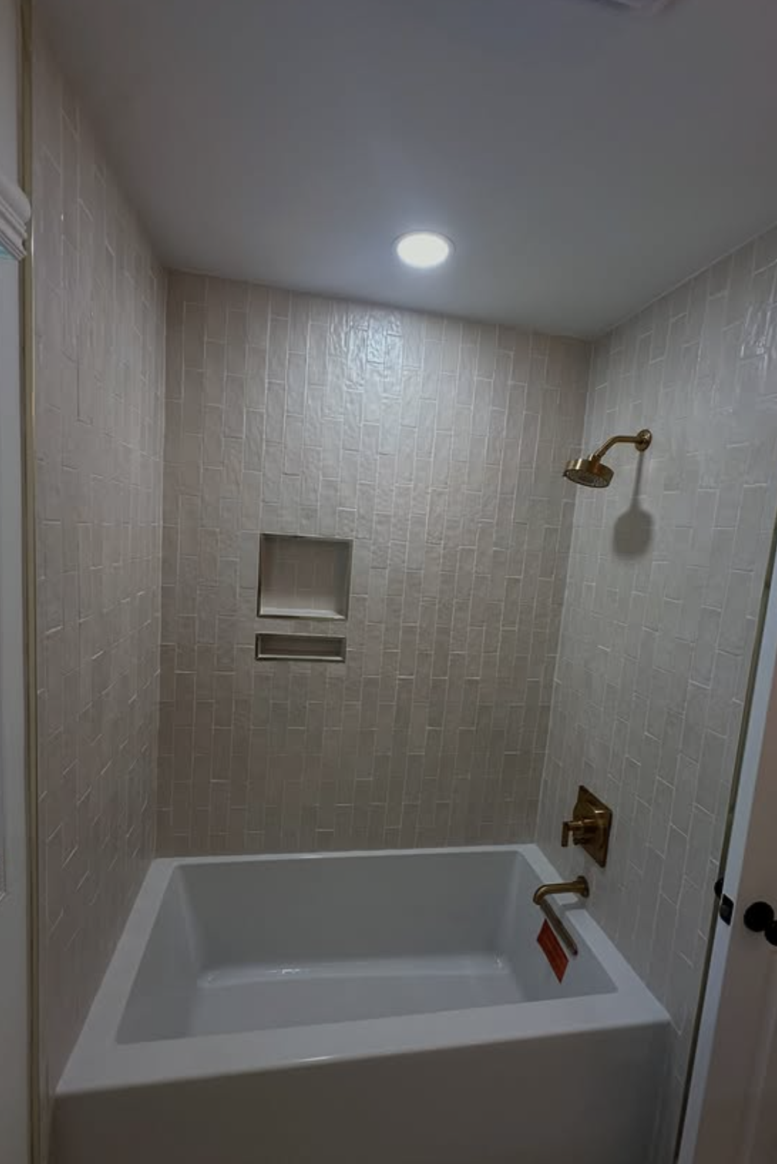 Vertical tile tub and shower by Zollinger Construction in Matawan, NJ
