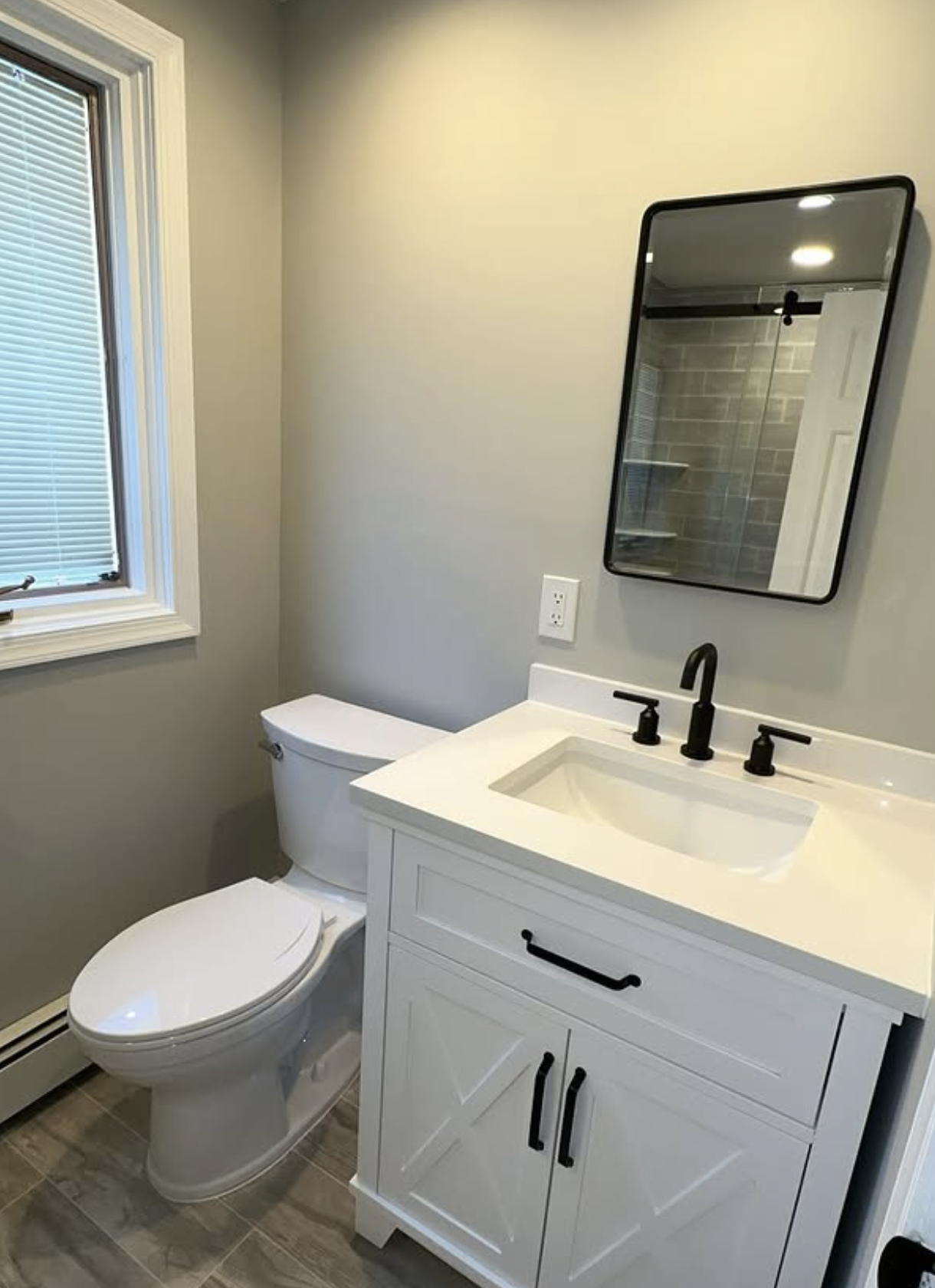 White vanity with black hardware by Zollinger Construction in Parlin, NJ