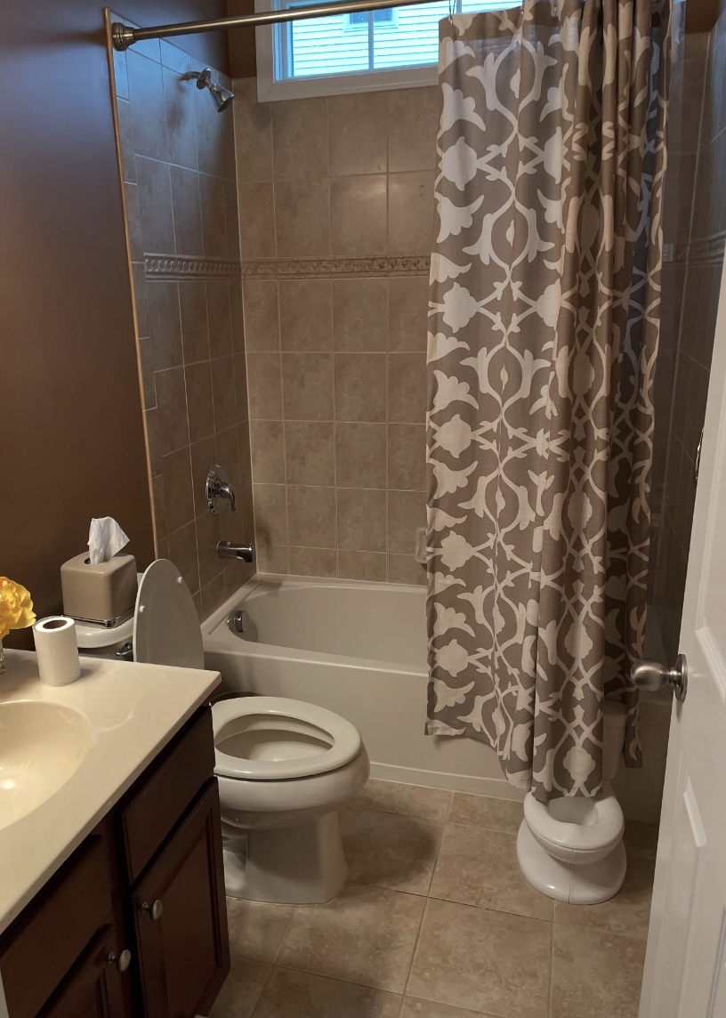 Dark tile tub and shower combo before bathroom remodel in Old Bridge, NJ
