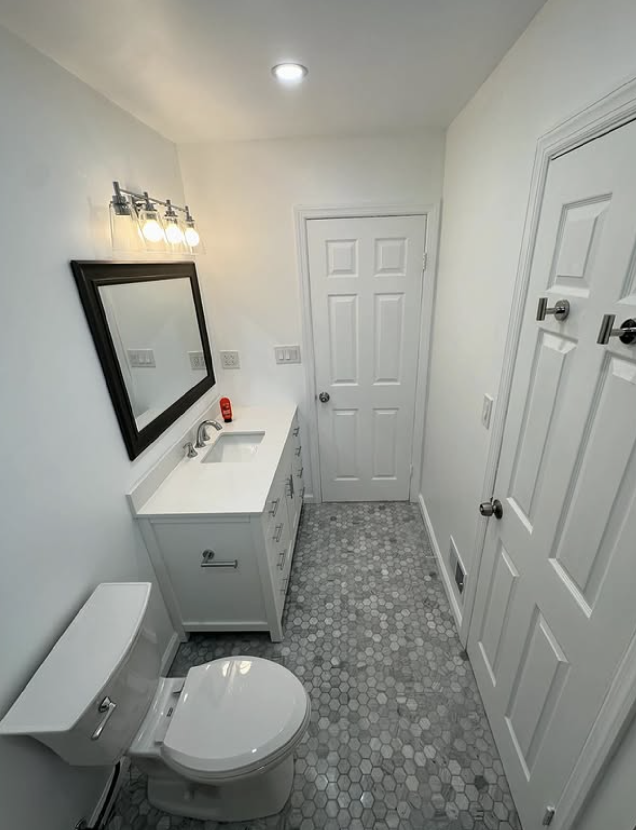 Bright hall bath with hex tile floor in Matawan, NJ