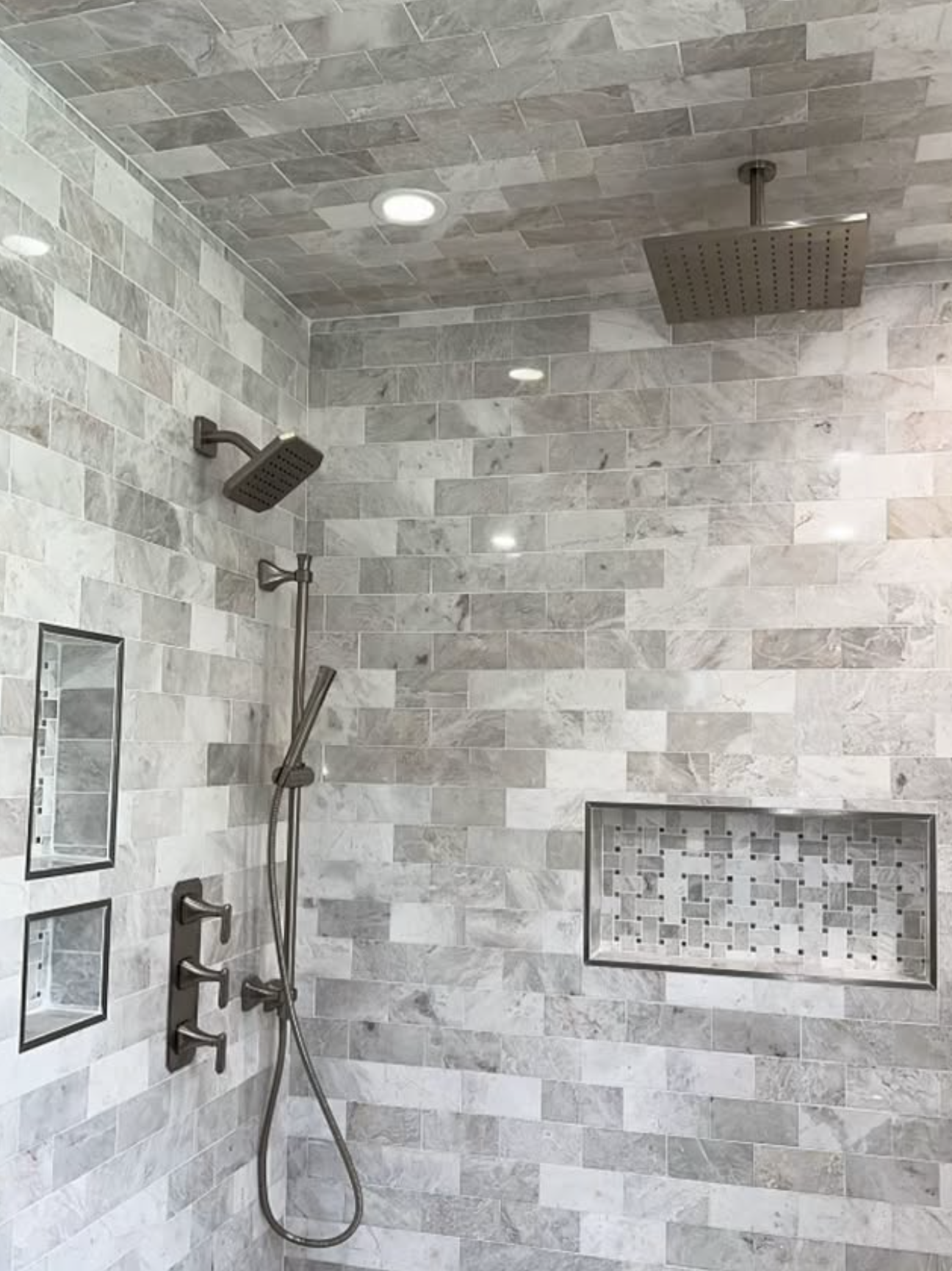 Marble tile shower with dual niches by Zollinger Construction in Keyport, NJ