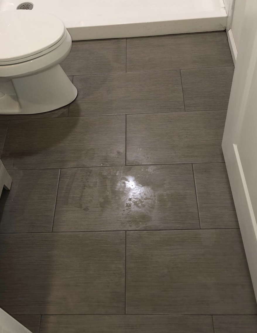 Large-format grey floor tile in finished bathroom in Parlin, NJ