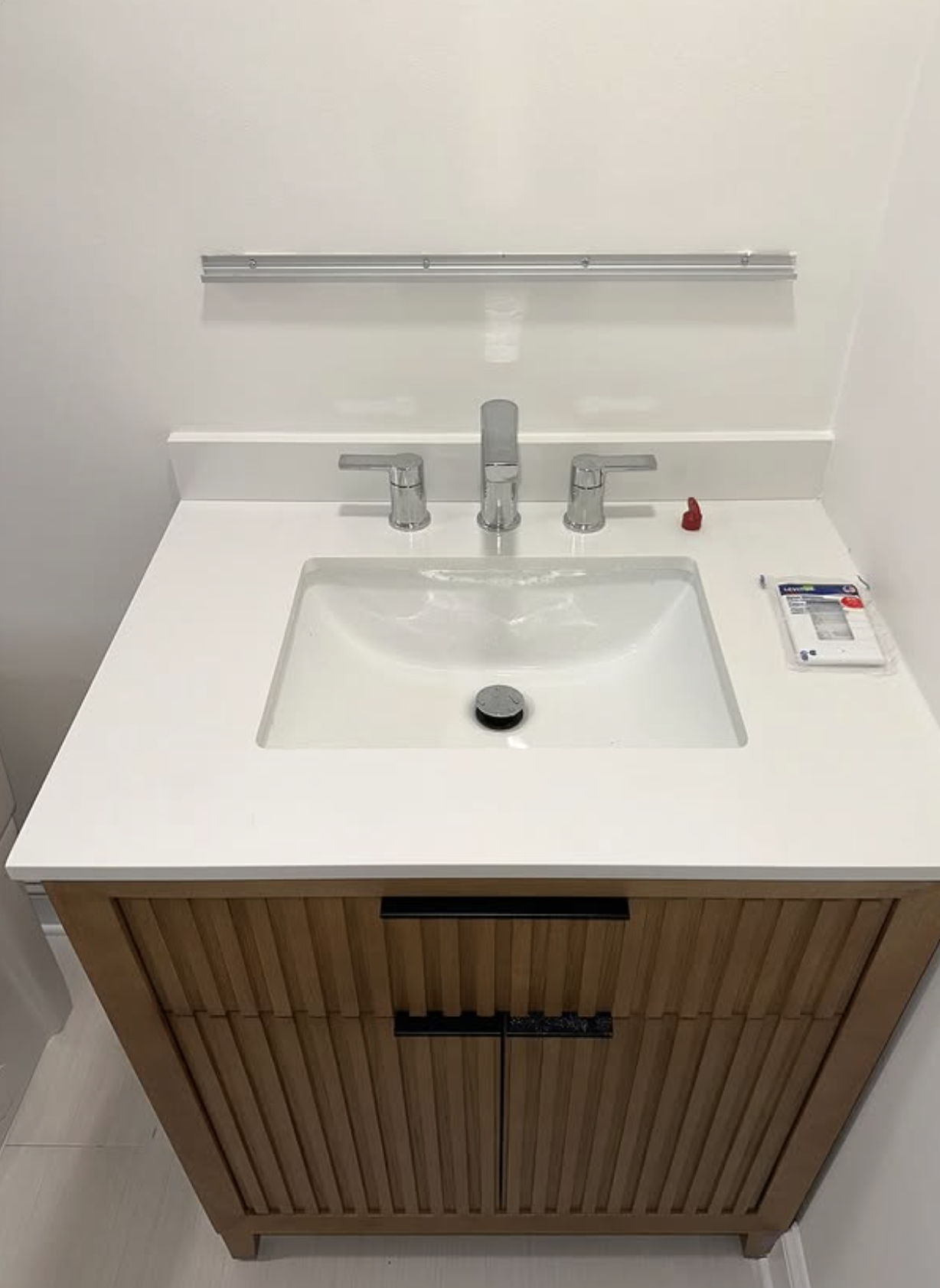 Floating vanity with integrated sink by Zollinger Construction in Parlin, NJ
