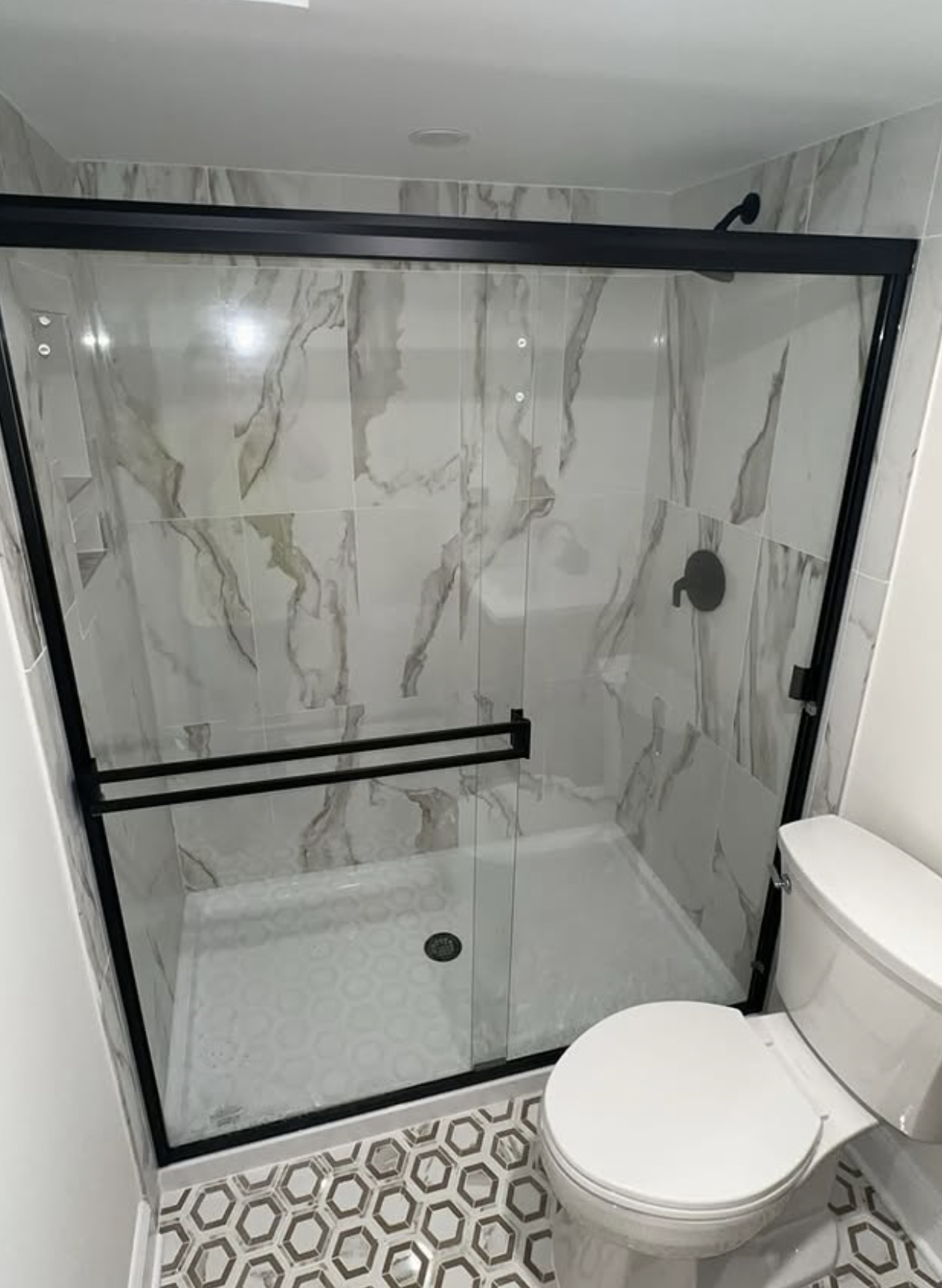 Black-framed marble shower by Zollinger Construction in East Brunswick, NJ