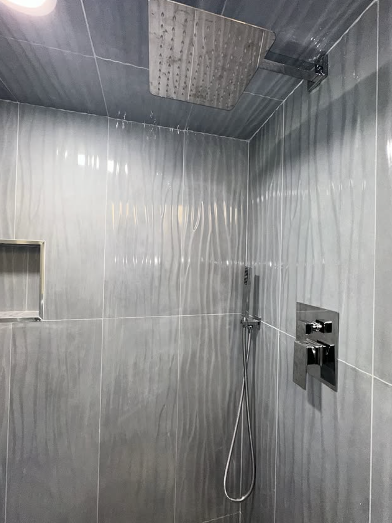 Grey wave-tile rain shower remodel in Spotswood, NJ