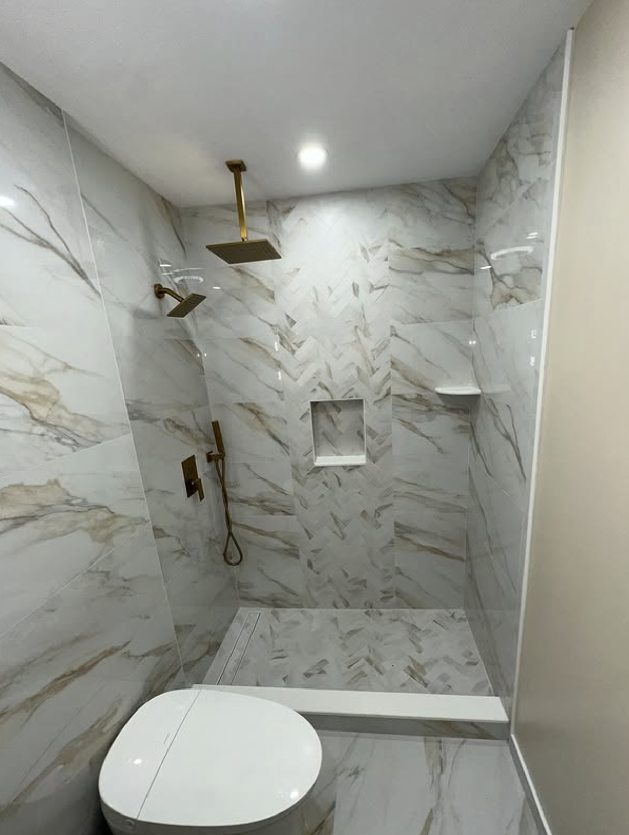 Marble bathroom shower with brass fixtures