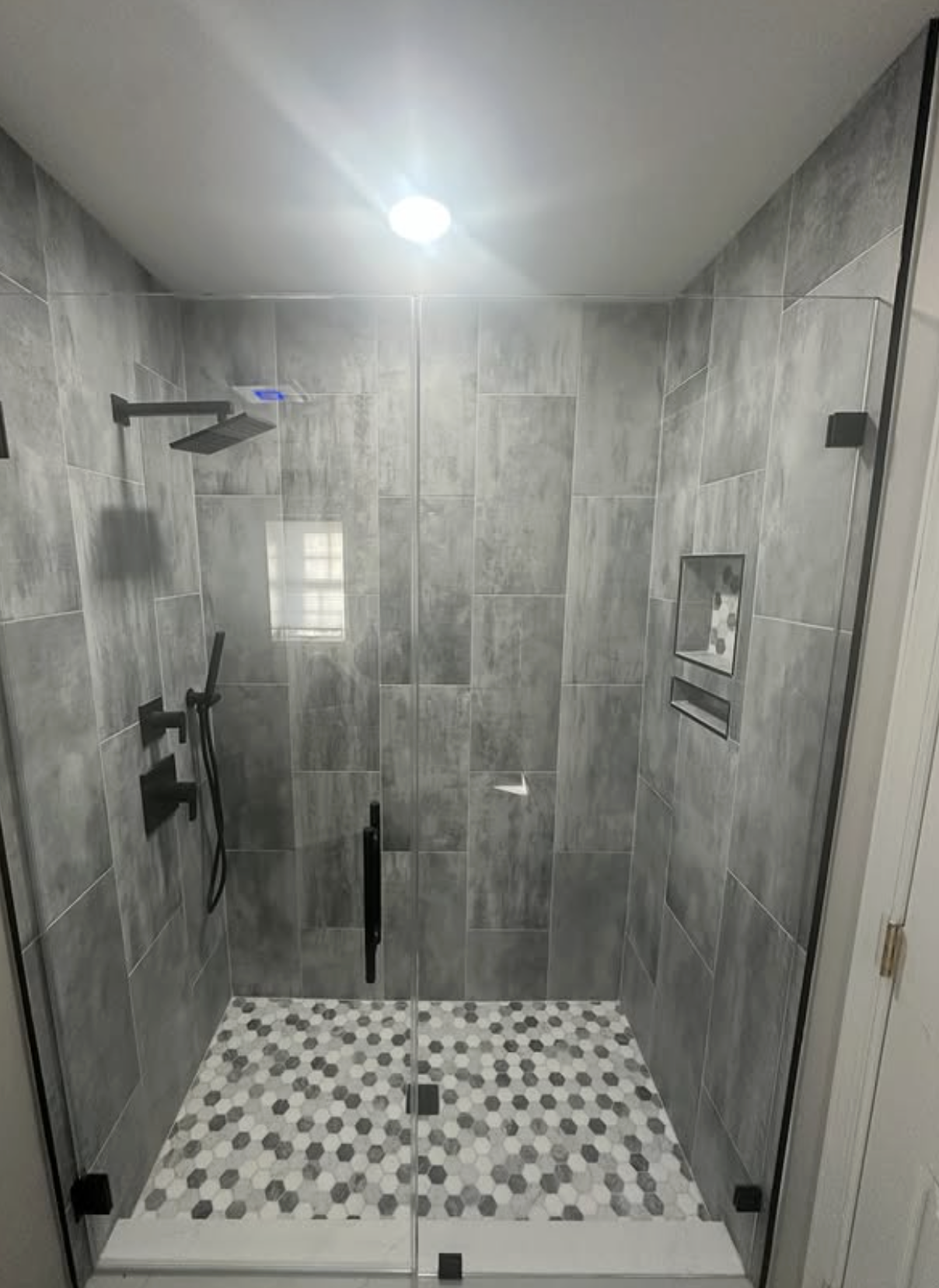 Glass shower with hex floor by Zollinger Construction in Aberdeen, NJ