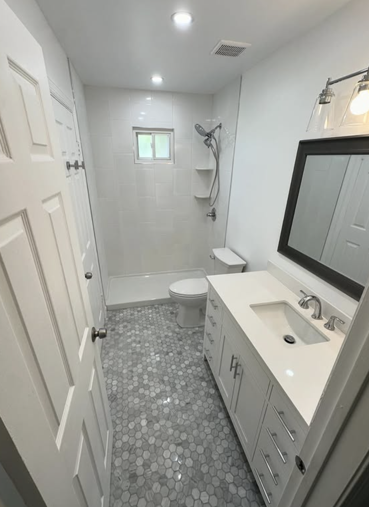Full hall bath remodel with shower base by Zollinger Construction in Perth Amboy, NJ