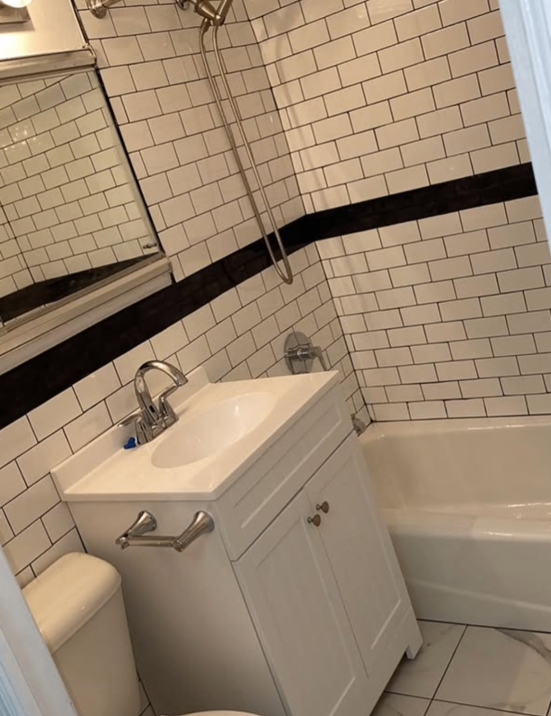 Compact subway tile bathroom by Zollinger Construction in Spotswood, NJ