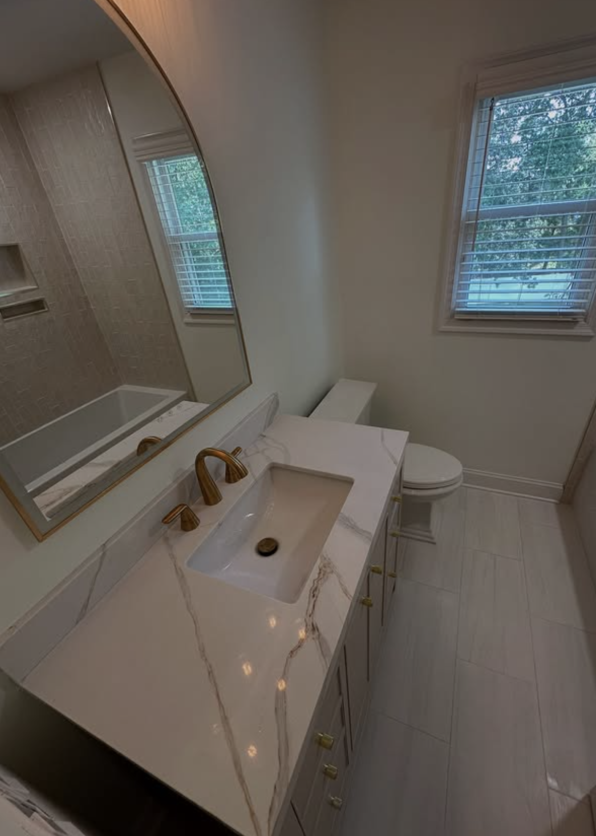 Quartz vanity with brass fixtures by Zollinger Construction in Spotswood, NJ