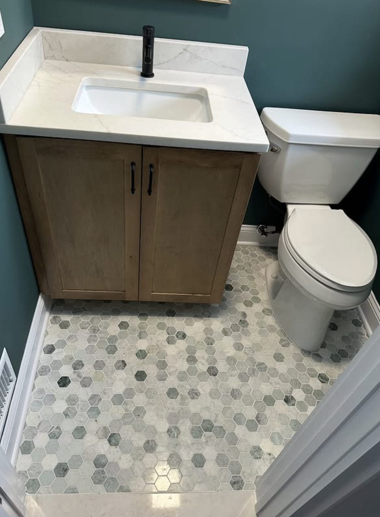 Powder room vanity and hex floor by Zollinger Construction in Spotswood, NJ
